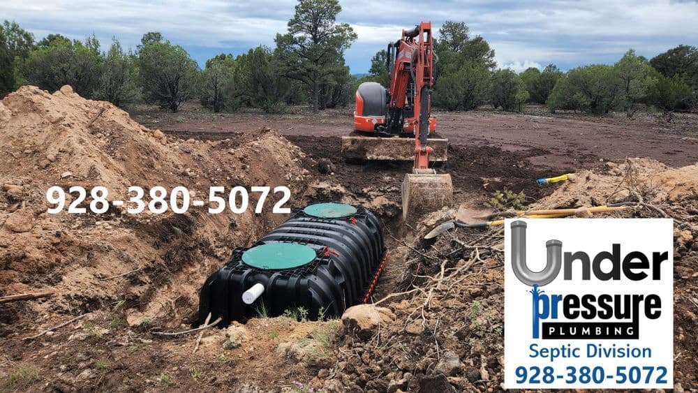Excavation for septic tank installation by Under Pressure Plumbing in forested area.